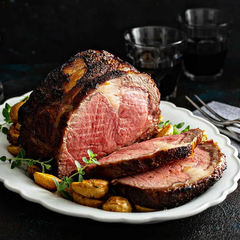 A sliced prime rib roast on a platter for a holiday dinner